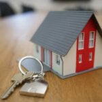 real estate keys on a table next to a house