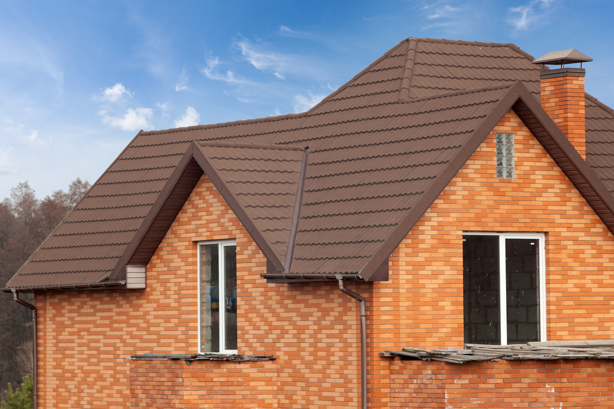 new brick house with modular chimney, stone coated metal roof tile, plastic windows and rain gutter